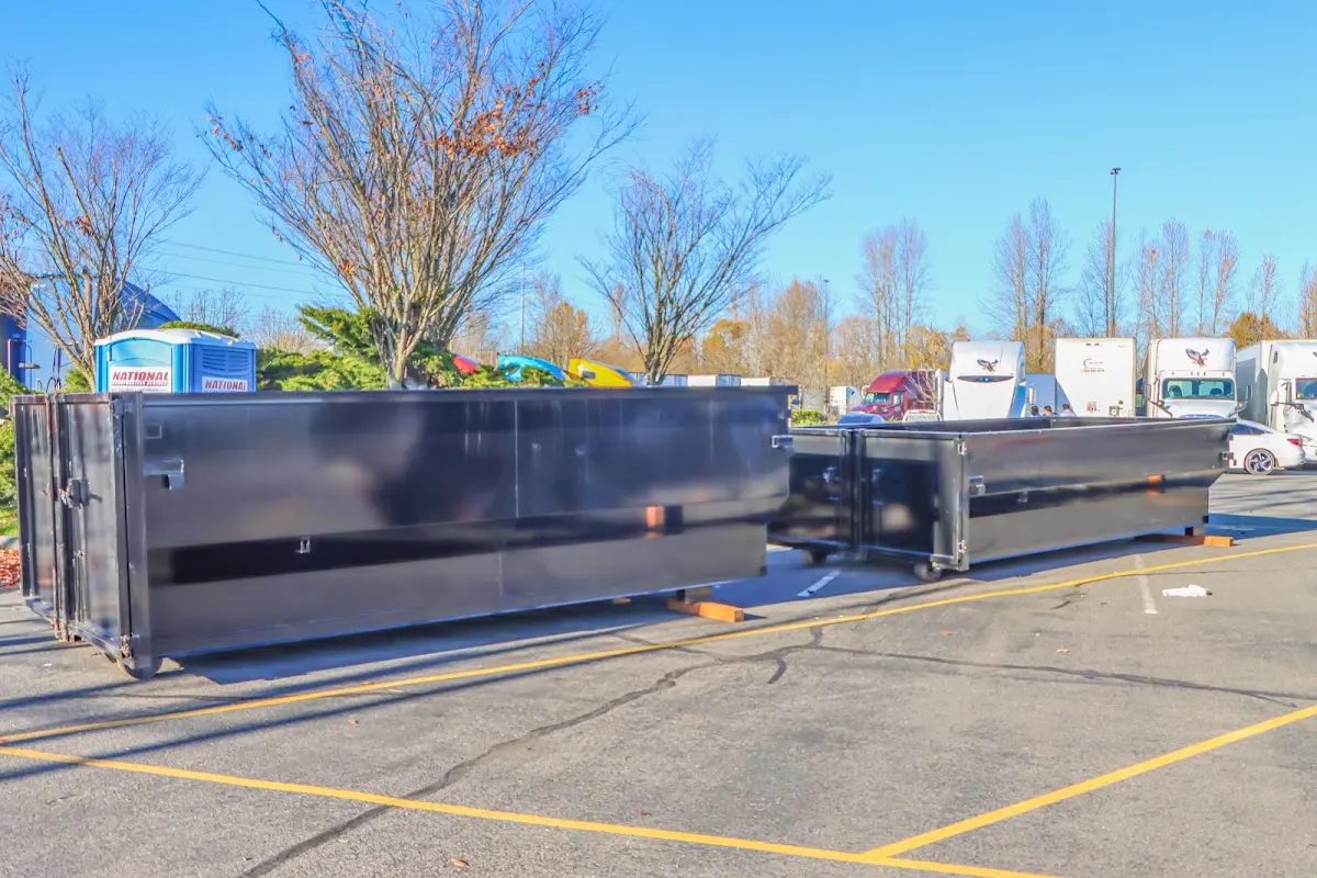 Professional dumpster rental service with roll-off container on residential driveway in Grayslake